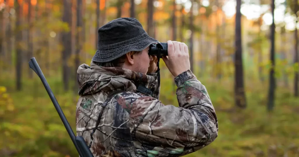 A hunter in California using binoculars for spot and stalk hunting.